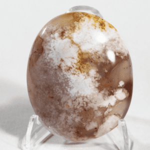 Oval gemstone with intricate white patterns